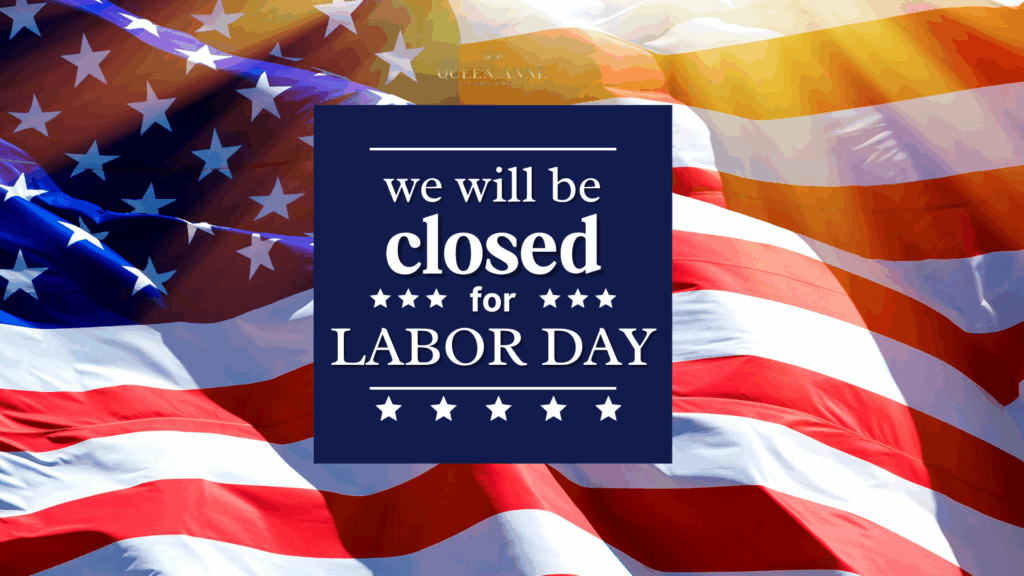A sign on an American flag background reads, "We will be closed for Labor Day." Sunlight shines on the flag, honoring hard work and dedication.