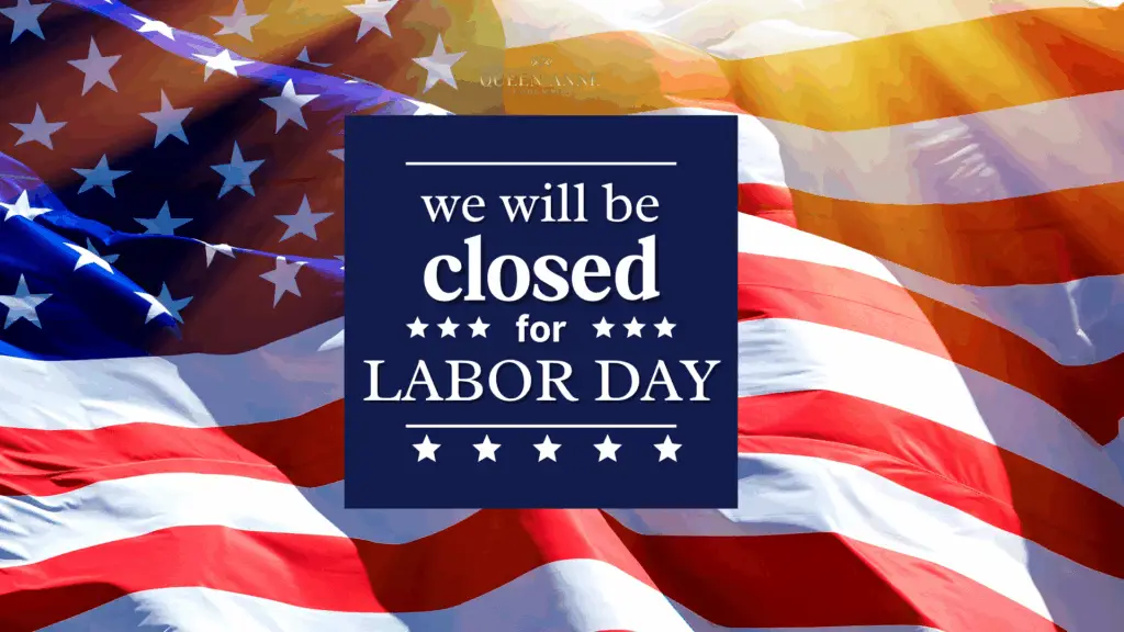 A sign on an American flag background reads, "We will be closed for Labor Day." Sunlight shines on the flag, honoring hard work and dedication.